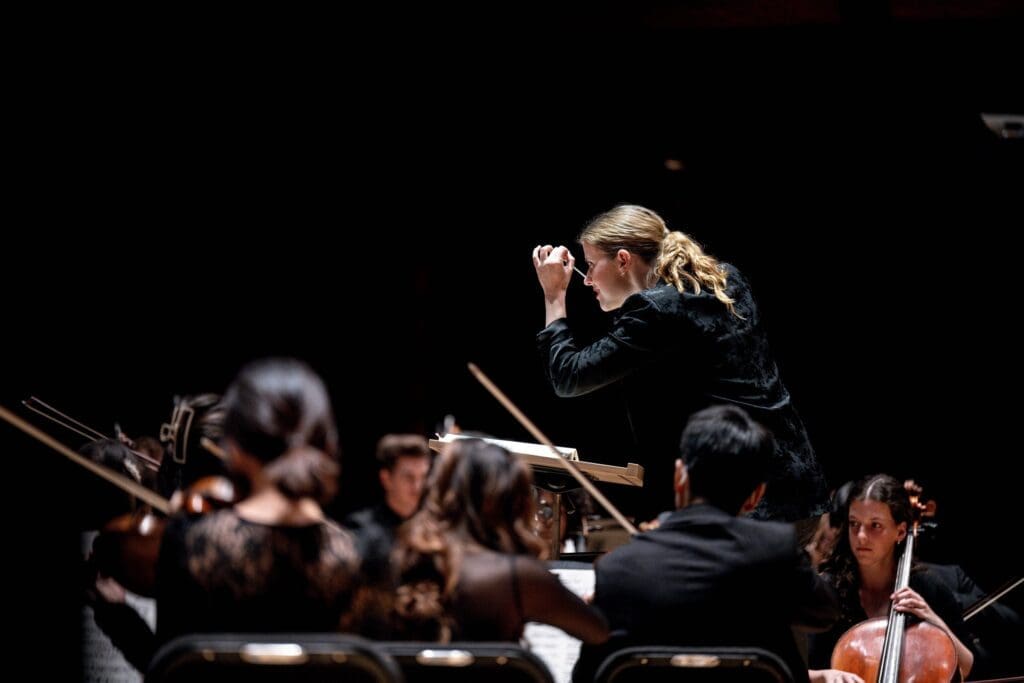 Micah Gleason conducting an orchestra